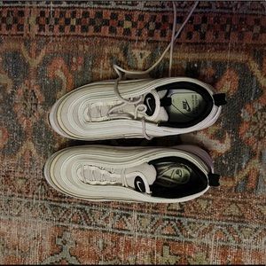Nike Air Max 97 in cream and white.